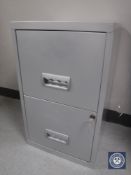 A two drawer metal filing cabinet with key