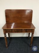 A Victorian mahogany foldover top tea table