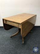 A Victorian mahogany Pembroke table on a four way pedestal