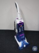A Vax Dual V Advance Reach carpet washer and bag of accessories and cleaning fluid