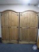 A pair of Mexican pine domed topped double door wardrobes