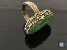 A Chinese silver gilt carved jade ring CONDITION REPORT: 7.0g. In good condition.