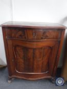 An antique continental mahogany cabinet fitted a drawer
