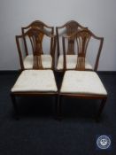 A set of four shield back dining chairs