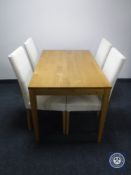 A pine kitchen table and four Ikea chairs