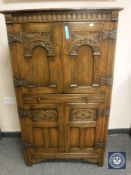 A good quality carved oak cocktail cabinet,