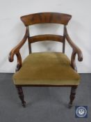 An antique mahogany scroll arm armchair