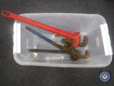 A crate of three heavy duty wrenches and a small pipe bender