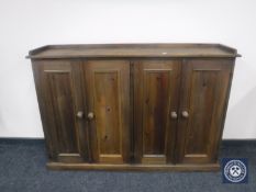 A narrow pine four door cabinet