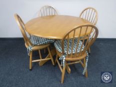 A circular beech kitchen table and four chairs