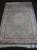 A Keshan rug on green ground, 2.00 m x 1.