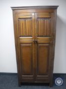 An oak linen fold hall wardrobe