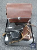 A leather cased Praktica Super TL camera together with a leather cased Adox Golf vintage camera and