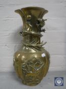 A Chinese embossed brass vase of dragon design,