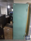 A two drawer metal filing cabinet with key together with a single door metal locker