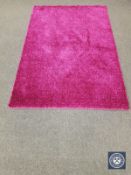A contemporary shaggy pile rug on purple ground,