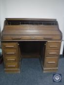 An Edwardian oak roll top desk