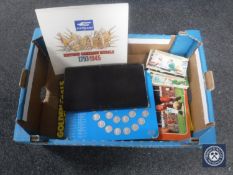 A box containing humorous postcards, Esso 1970 World Cup coin collection,