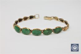 An 18ct gold jade set bracelet,