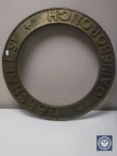 A circular brass engine plaque 
