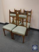 A set of four oak Arts & Crafts dining chairs
