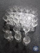 A tray containing thirty-one antique glasses