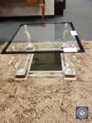 A contemporary Maison Charles glass topped designer coffee table with silvered horse head base,