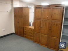 A three piece pine bedroom suite comprising of triple door wardrobe,