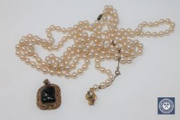 A silver gilt irregular shaped stone pendant,