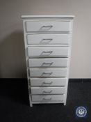 A mid 20th century painted narrow eight drawer chest