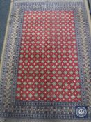 Two Persian hearth rugs together with a machine made Persian fringed rug