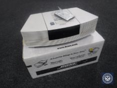 A Bose Wave radio CD player with remote,