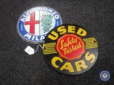 Two circular cast iron plaques;