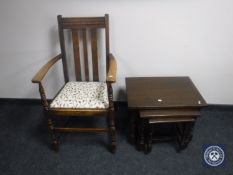 A nest of three oak tables together with an oak armchair