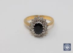 An 18ct gold sapphire and diamond cluster ring,
