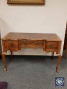 A burr walnut dressing table on pad feet,