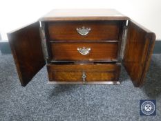 An Edwardian oak cabinet