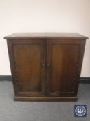 An Edwardian mahogany lift top double door cabinet