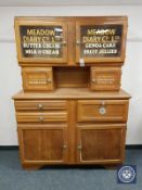 An early 20th century oak kitchen cabinet with advertising decoration,