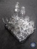 A tray containing antique and later glass ware together with two early 20th century glass decanters