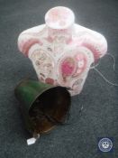A galvanized bucket in the form of a light fitting and an illuminated mannequin torso