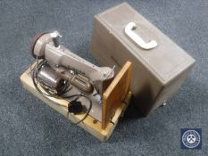A cased Singer electric sewing machine