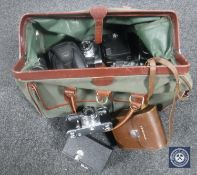 A hold all containing a quantity of vintage cameras