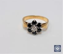 An 18ct gold sapphire and diamond cluster ring