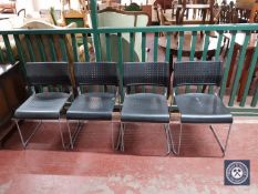 Four plastic stacking chairs