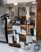 A contemporary all glass multi-panel mirror