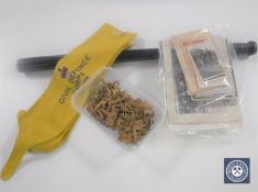 A collection of militaria to include a police truncheon, gilt metal badges,