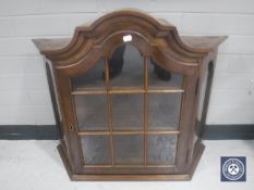 A glazed mahogany wall cabinet