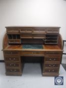 A walnut roll top bureau with green marble interior