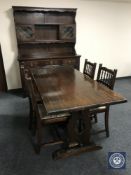An oak refectory dining table together with a set of four oak tapestry seated dining chairs